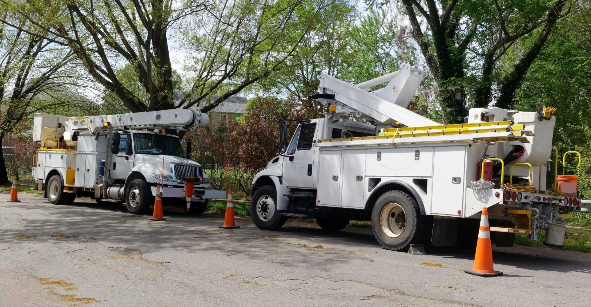 PrimeLink aerial lift bucket trucks staged for overhead fiber drop installation.